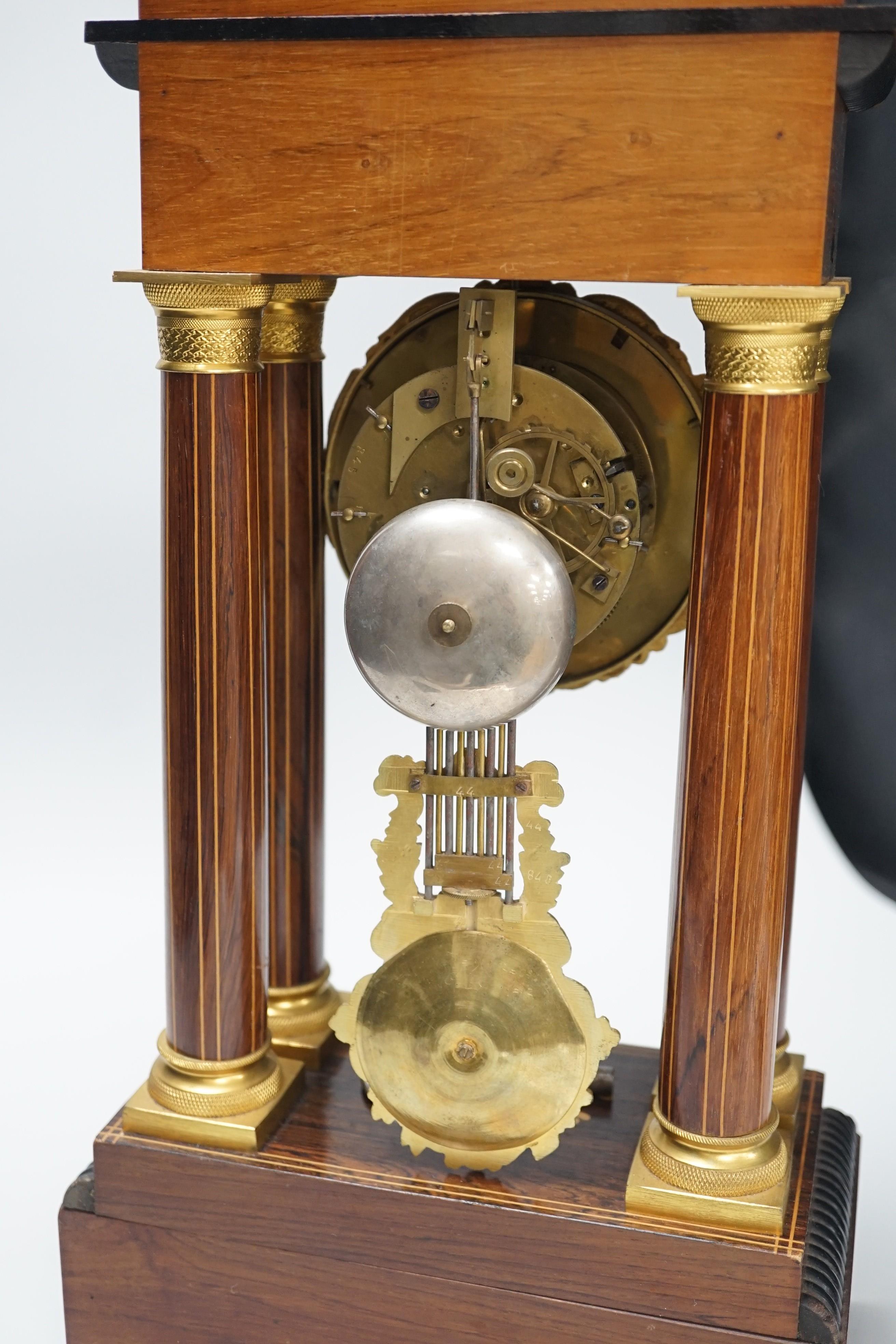 A late 19th century rosewood and marquetry portico clock with ormolu mounts